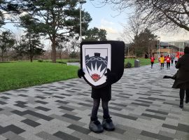 Salford Librarian runs Santa dash dressed as University emblem