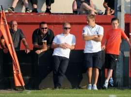 Paul Scholes (centre) and Phil Neville (2nd right) watch Salford City playing against Stalybridge Celtic.
