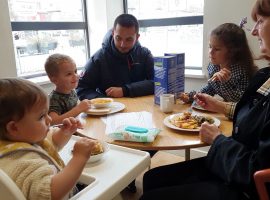 A family enjoying their free meal at Langworthy Cornerstone. Photo by: Ellie Kemp.