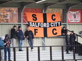 TANGERINE AND BLACK: Kedzior bringe his tangerine and black flag as a reminder that Salford City was a football club before the Class of 92 takeover in 2014.