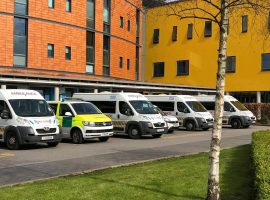 Ambulances line up at Salford Royal ready to take people home. Image credit: Holly Pritchard
