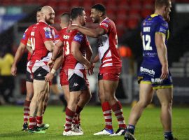 Salford Red Devils' Kallum Watkins (centre right) celebrates after the final whistle during the Coral Challenge Cup, Semi Final at The Totally Wicked Stadium, St Helens.