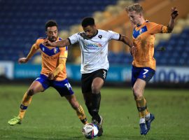 Mansfield Town's James Perch (left) and Harry Charsley (right) battle for the ball with Salford City's Ibou Touray (centre) during the Sky Bet League Two match at the One Call Stadium, Mansfield.