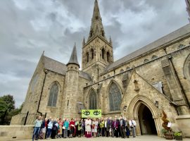 Right Reverend John Arnold and parishioners from Salford hold the ‘Eyes of the World’ banner outside of Salford Cathedral. Photo Credit: Holly Jones/Diocese of Salford