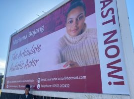 Mariama Bojang with her billboard on Kirkstall Road in Leeds
