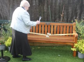 Gloria Egan cuts the ribbon and opens the bench to the public Credit: Age UK Salford, Paul Sherlock.