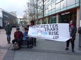 Members of Manchester Rise Up holding their protest sign. (Picture by Mel Cionco)