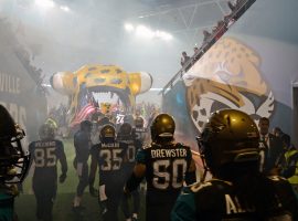 The National Football League’s Jacksonville Jaguars prepare to take the field Oct. 27, 2013, during the internationally televised game against the San Francisco 49ers at Wembley Stadium in London, England. At the front of the formation, U.S. Air Force Airman 1st Class James Taylor, 100th Security Forces Squadron patrolman, held the American flag and lead the charge onto the field. The NFL continues its Salute to Service campaign by giving Taylor and U.S. Air Force Airman Sara V. Summers, 48th Security Forces Squadron patrolman from RAF Lakenheath, the opportunity to lead rival football teams onto the field. (U.S. Air Force photo by Senior Airman Christine Griffiths/Released)