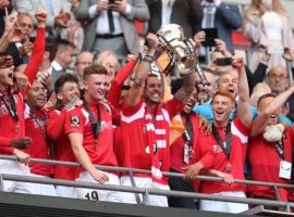 Salford City players celebrate with the trophy after winning the Vanarama National League Play-off Final at Wembley Stadium, London. Credit: PA Images