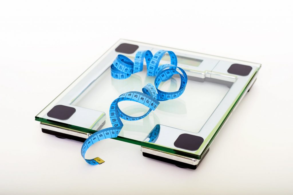 https://www.pexels.com/photo/blue-tape-measuring-on-clear-glass-square-weighing-scale-53404/