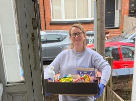 Volunteer for Humans MCR, Lorna, delivering service with a smile. Copyright: Lewey Hellewell.