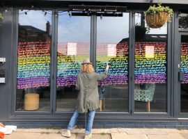 Emma Evans working on the window of the Blind Pig.