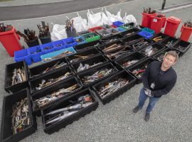 Sgt Paul Nolan with the recovered knives. Image Credit: GMP