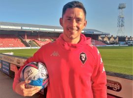 Look what dad's brought home! Ian Henderson with his hat-trick ball, signed by his teammates.