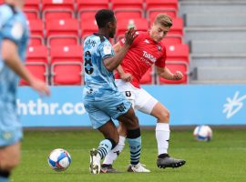 Golden getting the better of Forest Green Rovers midfielder, Ebrou Adams. Image courtesy of Salford City FC.