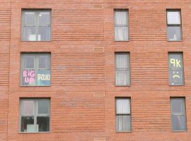 Some messages written in post-it notes in the windows of Peel Park Quarter's Lowry building. Image credit: Matthew Lanceley