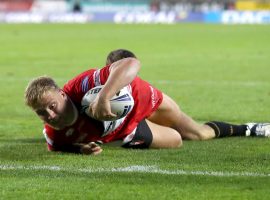 Salford Red Devils' James Greenwood dives in to score a try during the Betfred Super League match at Totally Wicked Stadium, St Helens.