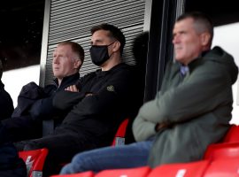 Salford City co-owners Paul Scholes (left) and Gary Neville (centre) with Roy Keane in the stands during the Sky Bet League Two match at The Peninsula Stadium, Salford. Credit: PA Images