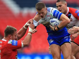 Leeds Rhinos' Ash Handley (right) is tackled by Salford Red Devils Lee Mossop during the Coral Challenge Cup Final at Wembley Stadium, London. Image credit: PA Images