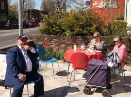 Critchley regulars enjoy food and drink in the sun together.