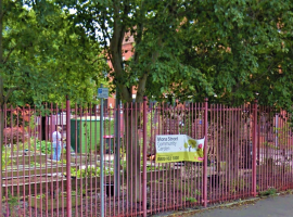 Off road photo of Mona Street Community Garden sign