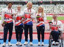 Maguire (pictured right) after winning his silver medal with the mixed relay team.