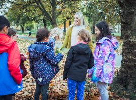 Children gather around mindfulness coach Jessica Walker