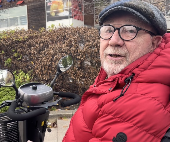 Alex outside Tesco on his mobility scooter