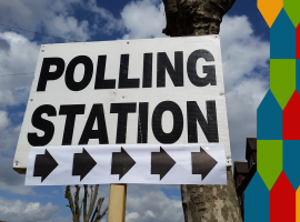 Polling station with graphic. Photo credit Flickr CC: https://www.flickr.com/photos/bagelmouse/17246052428