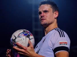 Matt Smith picks up his fist match ball in Salford City colours