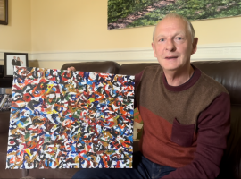 Philip Westcott holding his award winning painting. Photo courtesy of Manuela Sanchez Lopez.