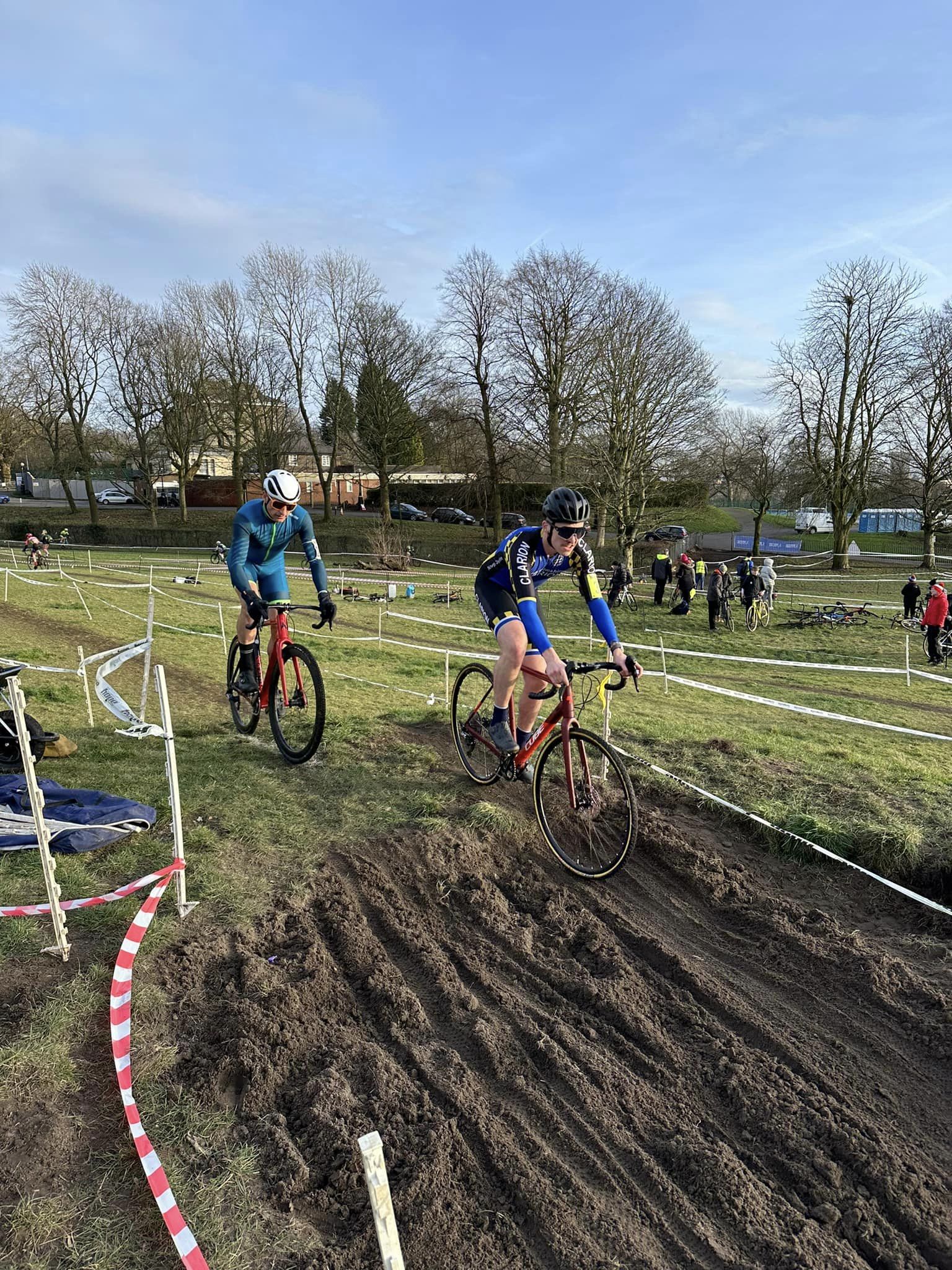 Image of cyclists crossing over some mud 