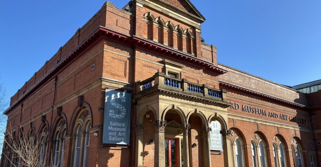 https://www.google.com/maps/place/Salford+Museum+%26+Art+Gallery/@53.4851429,-2.2717622,3a,75y/data=!3m8!1e2!3m6!1sAF1QipPo4FmL4O8HyHDPqiQEczSprBqRR5YSVLm9U_QP!2e10!3e12!6shttps:%2F%2Flh5.googleusercontent.com%2Fp%2FAF1QipPo4FmL4O8HyHDPqiQEczSprBqRR5YSVLm9U_QP%3Dw114-h86-k-no!7i4032!8i3024!4m7!3m6!1s0x487ba87d6e3eaf4f:0xd22b56c228e5a657!8m2!3d53.4851429!4d-2.2717622!10e5!16zL20vMDRfYmxt?entry=ttu&g_ep=EgoyMDI0MDkyNS4wIKXMDSoASAFQAw%3D%3D