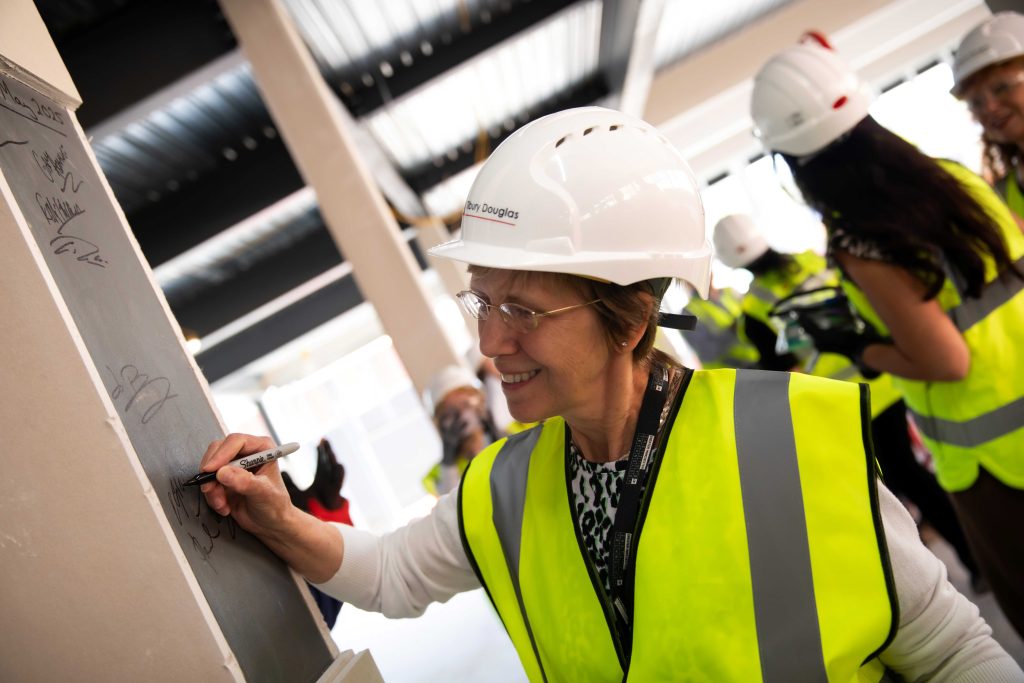 ni of Salford - GMIoT Director Claire Foreman signs the steel post in the new building (1)