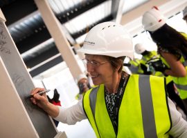 ni of Salford - GMIoT Director Claire Foreman signs the steel post in the new building (1)
