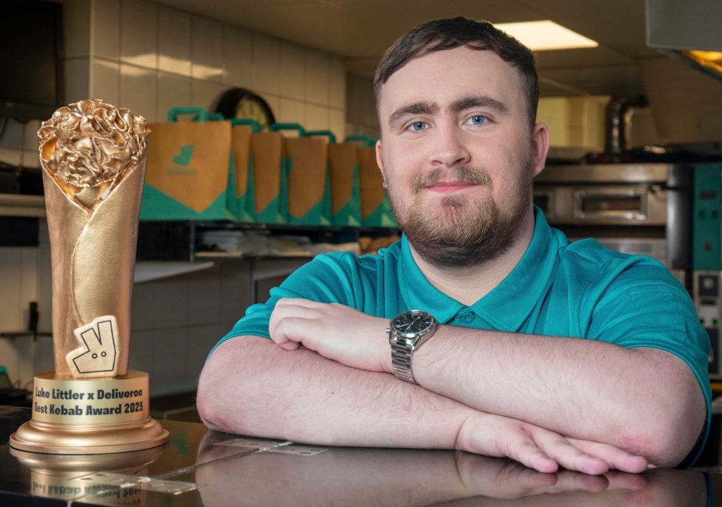 Luke Littler with the trophy - Deliveroo