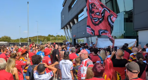 Salford Red Devils supporters march in protest with hundreds in attendance