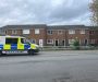Police scene in Salford neighbourhood after shooting leaves bullet holes in windows