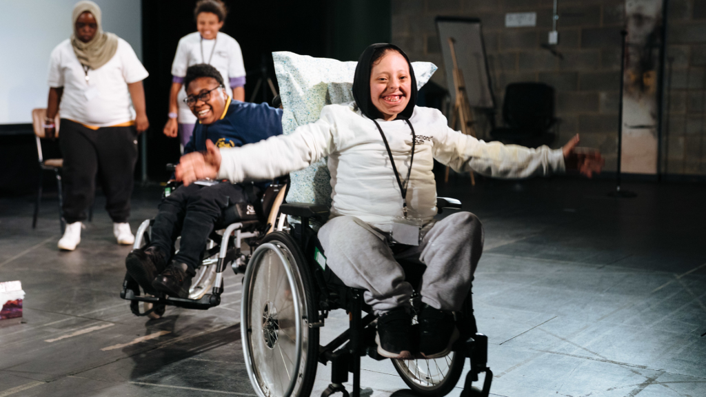 Girl in a wheelchair in a theatre.