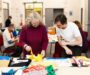 Exhibition featuring banners created by Salford community tours city